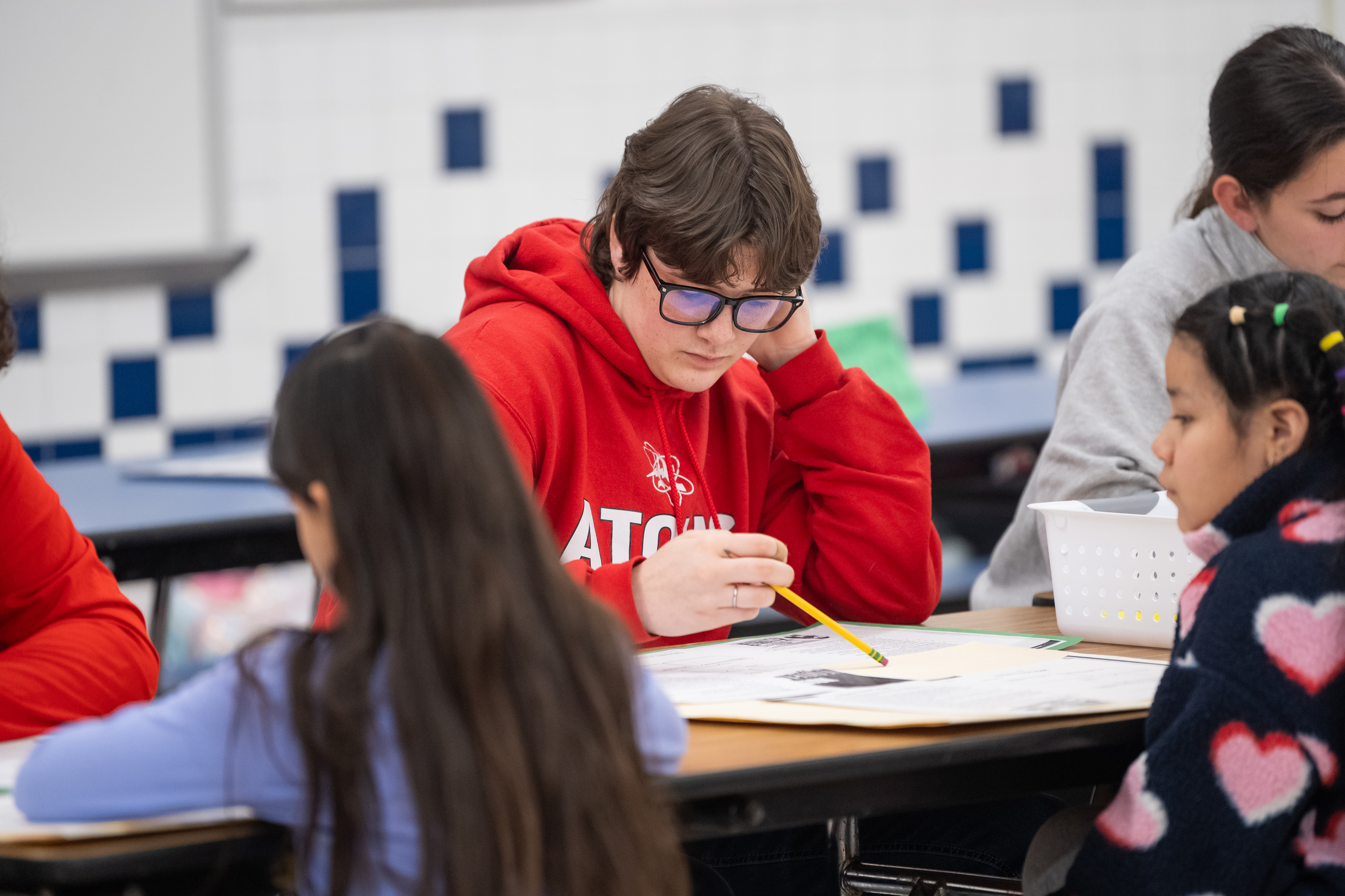 An Annandale High School basketball player reviews a student's work.