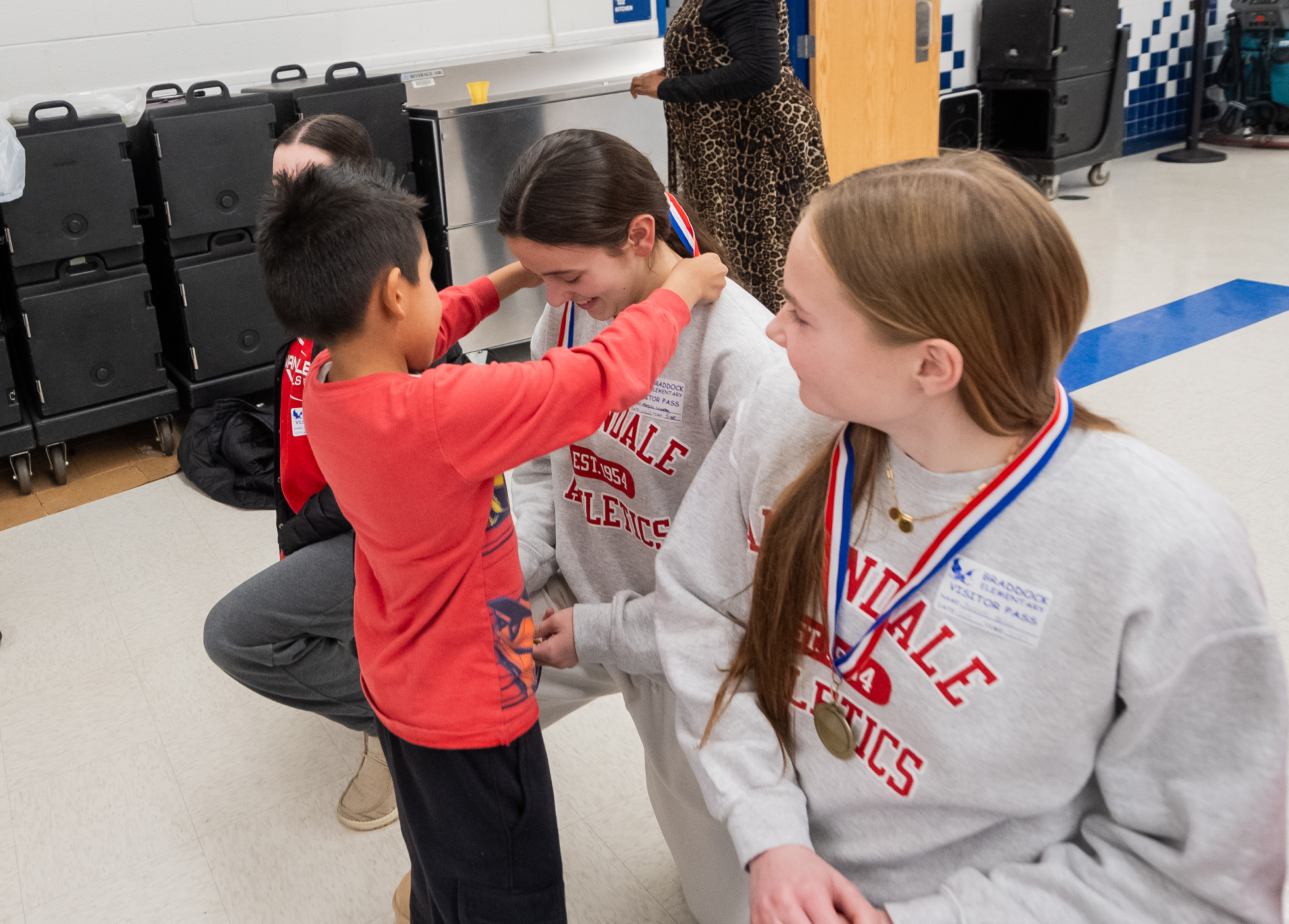 Braddock students award medals to their mentors.