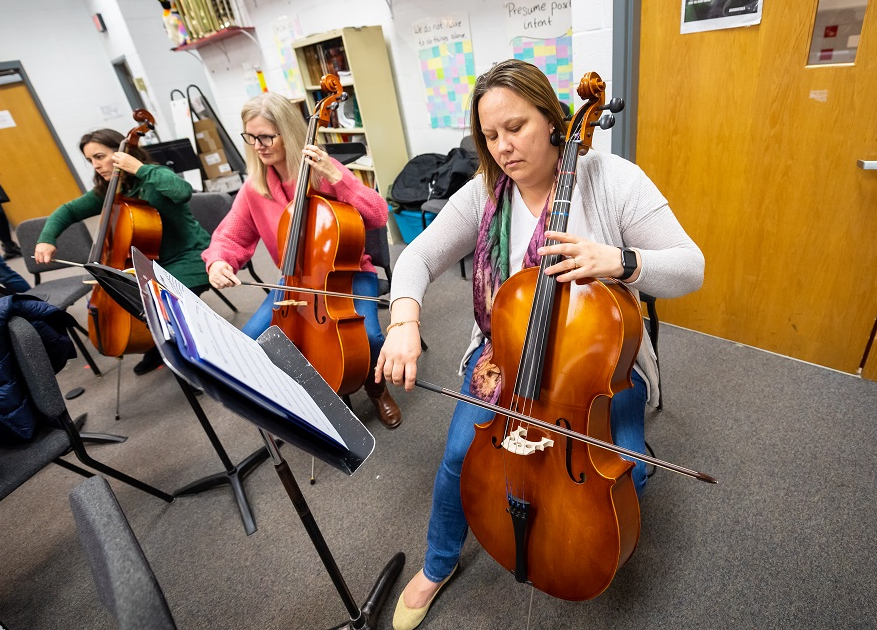  Parents play their instruments during an orchestra practice. 